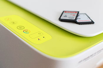 Detailed shot of a printer's control panel with SD cards on top, highlighting modern tech. HD wallpaper