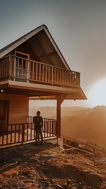 Silhouette of a person on a balcony with a stunning sunset over Panamanian hills. HD phone wallpaper