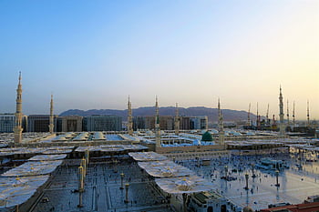 Aerial view of Al-Masjid an-Nabawi with minarets at sunset in Medina, Saudi Arabia. HD wallpaper