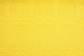 Close-up of a decorative yellow embossed with an intricate repeating pattern. HD wallpaper