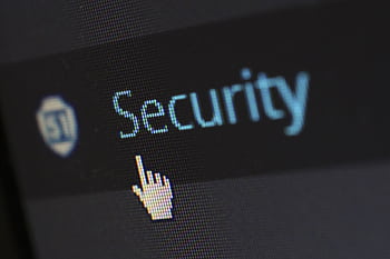 Close-up view of a mouse cursor over digital security text on display. HD wallpaper