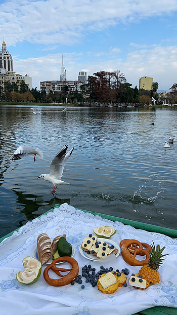 Riverside travels, Various products on, Blanket near river, stock HD phone wallpaper