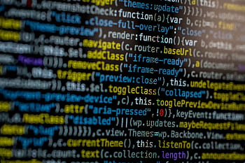 An extreme close-up of colorful programming code on a computer screen, showcasing development and software debugging. HD wallpaper