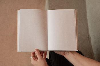 Hands holding an open blank notebook, perfect for concept or design projects with ample copy space. HD wallpaper