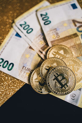 Close-up of Euro banknotes with Bitcoin coins on a glittery background symbolizing modern currency and investment. HD phone wallpaper
