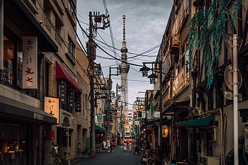Vibrant urban street scene in Shinjuku City, Tokyo with a view of Tokyo Skytree. HD wallpaper