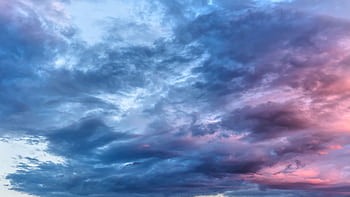 A tranquil cloudscape at dusk with soft pink and blue hues, creating a serene atmosphere. HD wallpaper