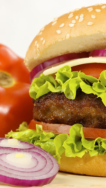Burger artistry, Crispy lettuce garnish, Handheld delight, Irresistible temptation HD phone wallpaper