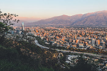 Breathtaking view of Santiago, Chile's skyline framed by mountains at sunset. HD wallpaper
