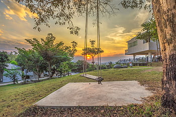 Peaceful garden scene with swing at sunset in Tambon Nong Chaeng, Thailand. HD wallpaper