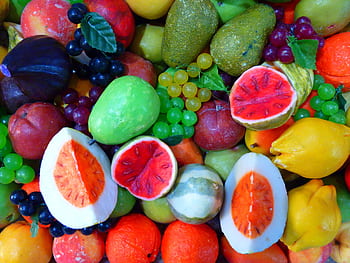 A diverse and vibrant array of colorful fruits, featuring various shapes and textures. HD wallpaper