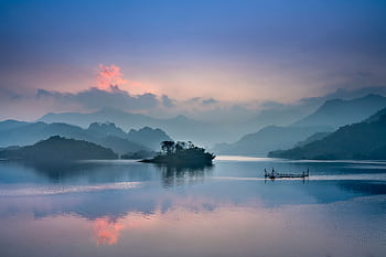 Tranquil lake with misty mountains at sunrise in Thượng Lâm, Vietnam. HD wallpaper
