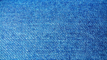 Detailed close-up of blue denim fabric showcasing texture and weave pattern. HD wallpaper