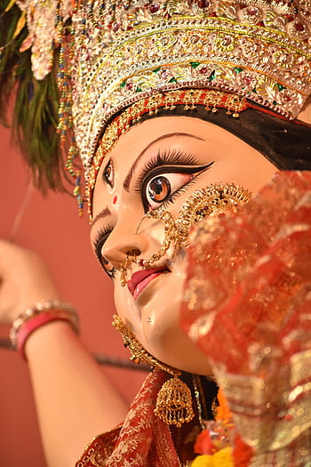 Detailed close-up of a vibrant Durga statue during Durga Puja in Munger, India. HD phone wallpaper