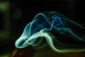 Dynamic smoke waves captured in green and blue hues on a dark backdrop. HD wallpaper