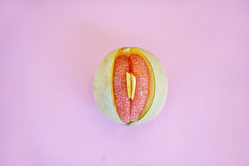 Artistic of a grapefruit with a pink backdrop. Abstract and conceptual. HD wallpaper