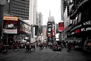 Dynamic scene of Times Square showcasing bustling urban life and iconic billboards in New York City. HD wallpaper