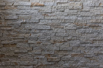 High-resolution of a rustic stone wall perfect for backgrounds, emphasizing texture and design. HD wallpaper