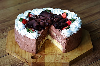 A visually enticing chocolate cake with strawberries and cream, perfect for desserts and celebrations. HD wallpaper