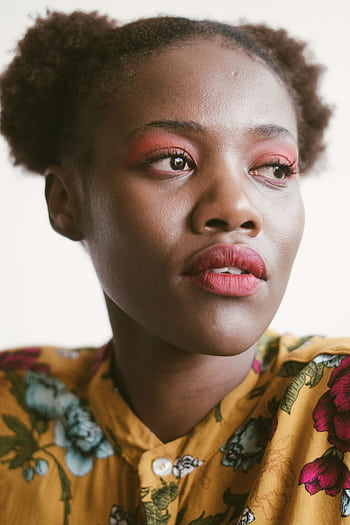 Close-up portrait of a stylish young woman with floral attire and vibrant makeup. HD phone wallpaper