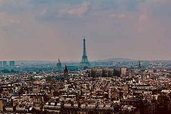 Explore the stunning panoramic cityscape of Paris with the iconic Eiffel Tower rising above the urban landscape. HD wallpaper