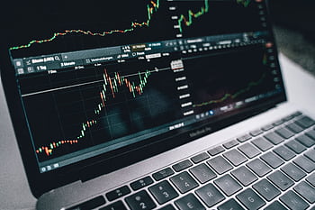 Close-up of a financial graph on a laptop screen, depicting stock market analysis in Berlin. HD wallpaper