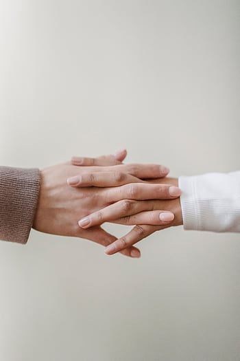 Two hands coming together gently, symbolizing connection and trust. HD phone wallpaper