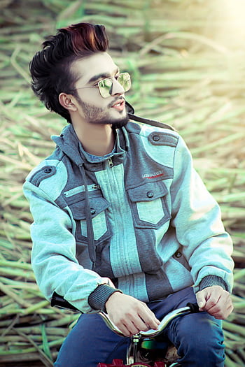 Trendy young man wearing sunglasses and a jacket, posing outdoors. HD phone wallpaper