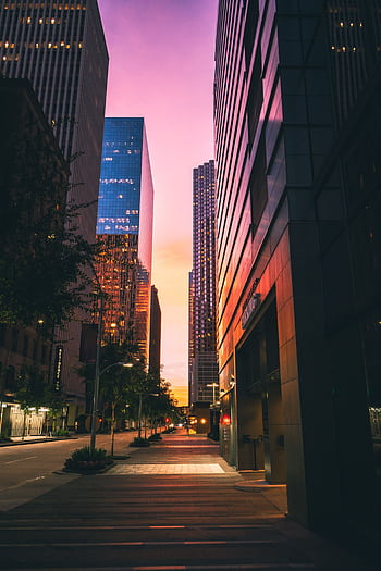 Captivating view of Houston's skyscrapers with a vibrant sunset backdrop, ideal for urban graphy. HD phone wallpaper
