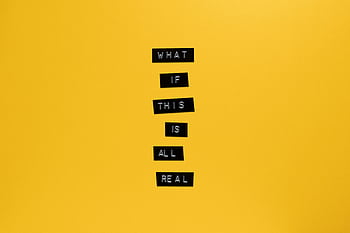 Inspirational text 'What if this is all real' on yellow surface. HD wallpaper