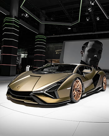 Stunning gold Lamborghini sports car displayed in Frankfurt's auto exhibition hall. HD phone wallpaper