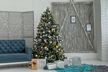 A beautifully decorated living room with a Christmas tree and gifts, creating a festive holiday atmosphere. HD wallpaper