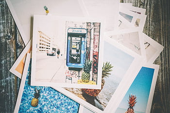 Vintage-style travel prints with a nostalgic feel on a wooden surface. HD wallpaper