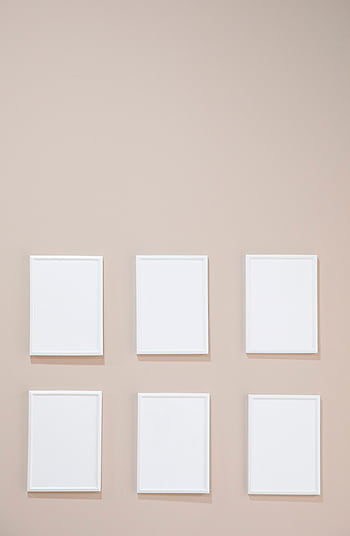 Empty white frames arranged on a beige wall, perfect for modern interior decor mockups. HD phone wallpaper
