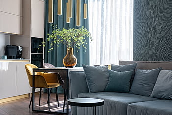 Stylish and elegant living room interior featuring modern furniture, soft seating, and chic decor. HD wallpaper