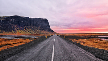 Road Between Dry Grass Lake Mountains Under White Clouds Sky During Sunset Nature HD wallpaper