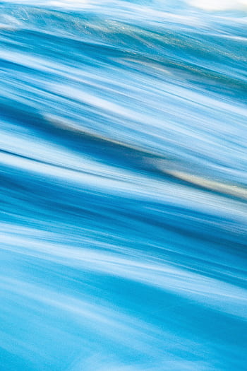 Vibrant abstract motion blur with shades of blue creating a dynamic texture. HD phone wallpaper