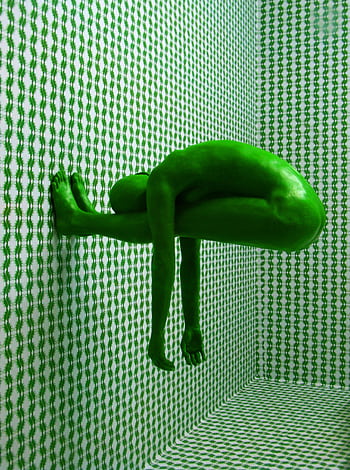 Artistic green human figure against a patterned and textured wall. HD phone wallpaper