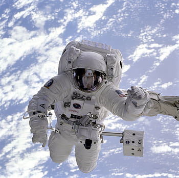 Astronaut conducting a spacewalk with Earth in the background, showcasing outer space exploration. HD wallpaper