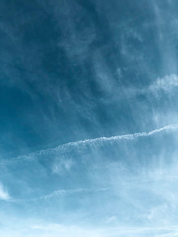 Bright blue sky with wispy clouds, creating a serene and open atmosphere, perfect for backdrop use. HD phone wallpaper