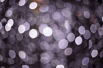 A mesmerizing bokeh effect with circular light patterns creating a sparkling abstract texture. HD wallpaper