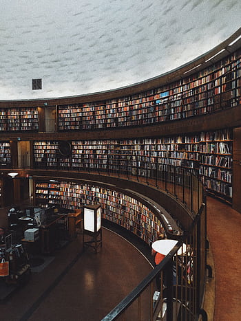Explore a stunning circular library with endless bookshelves, offering a haven of knowledge and tranquility. HD phone wallpaper