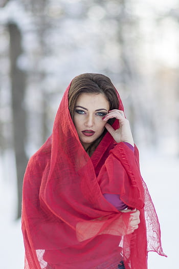 Outdoor portrait of an elegant woman in a red hijab posing against a winter background. HD phone wallpaper