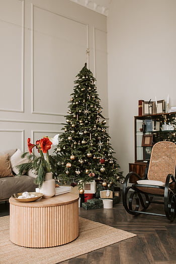 Cozy Christmas-themed living room with a decorated tree, modern furniture, and festive decor. HD phone wallpaper