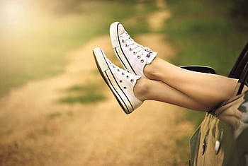 White sneakers out of car window on a sunny dirt road, portraying dom. HD wallpaper