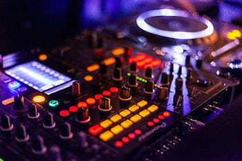 Vibrant DJ mixer with illuminated controls, perfect for music and technology themes. HD wallpaper