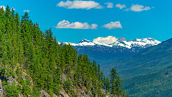 Landscape View Of Mountains With Snow Green Trees Forest Slope Under White Clouds Blue Sky Nature HD wallpaper