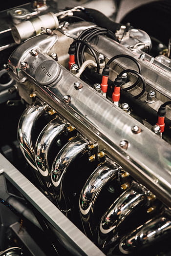 Detailed view of a polished chrome engine, showcasing luxury automotive design. HD phone wallpaper