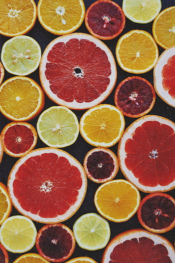 Bright and fresh assortment of colorful citrus fruit slices captured from above. HD phone wallpaper