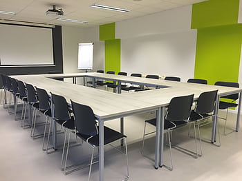Bright and modern conference room with U-shaped table setup, perfect for meetings and presentations. HD wallpaper